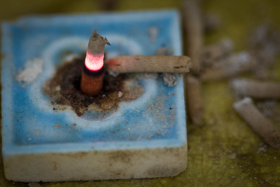 Burning sandalwood incense stub and burner